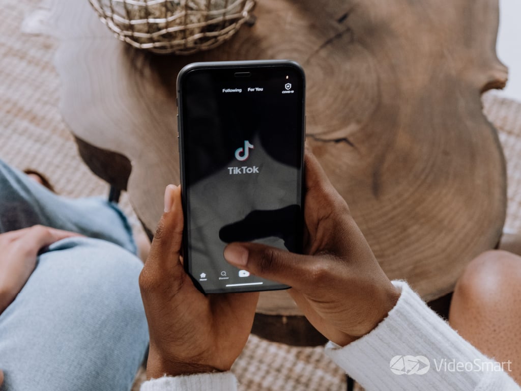 Person with a phone in their hand with Tiktok app open